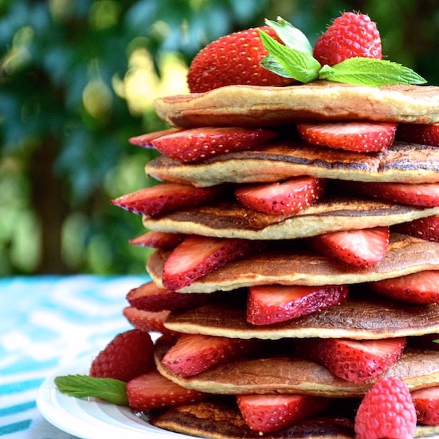 Stacked pancakes with fresh strawberries